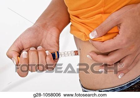 young woman's hand injecting insulin against diabetes close up View Large Photo Image Stock Photograph - young woman's hand injecting insulin against diabetes close up. Fotosearch