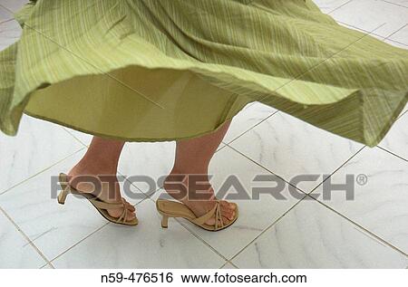 Young woman's legs in a dance motion on tile floor View Large Photo Image Stock Photograph - Young woman's legs in a dance motion on tile floor. Fotosearch