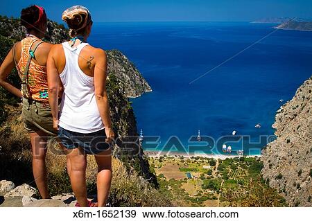 Stock Photo - Young women and Coastline landscape Butterfly Valley, Faralya, Lycian Way Mugla, Mugla province, Aegean coast, Turkey. Fotosearch
