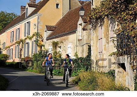 young women cycling in the village of Villeray, Commune of Condeau, Orne department, Lower Normandy region, France, Western Europe. View Large Photo Image Stock Photo - young women cycling in the village of Villeray, Commune of Condeau, Orne department, Lower Normandy region, France, Western Europe.. Fotosearch