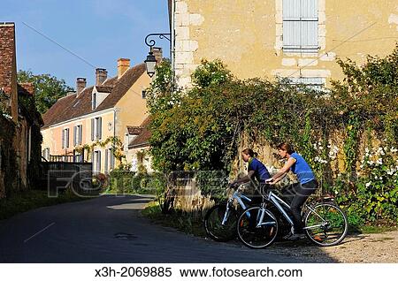young women cycling in the village of Villeray, Commune of Condeau, Orne department, Lower Normandy region, France, Western Europe. View Large Photo Image Stock Photography - young women cycling in the village of Villeray, Commune of Condeau, Orne department, Lower Normandy region, France, Western Europe.. Fotosearch