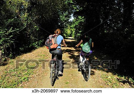 Stock Photo - young women cycling, Orne department, Lower Normandy region, France, Western Europe.. Fotosearch