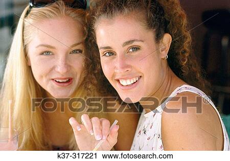 Young women, drinking fruit juices View Large Photo Image Stock Image - Young women, drinking fruit juices. Fotosearch
