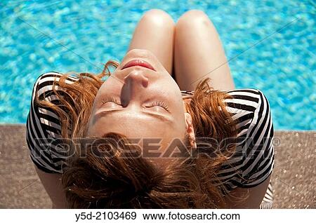 young women enjoying sunshine at the poolside View Large Photo Image Stock Photo - young women enjoying sunshine at the poolside. Fotosearch