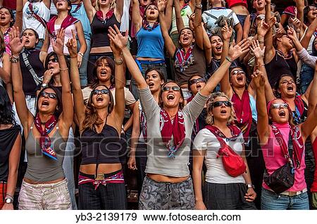 Young Women From The Tower Contrada Cheer On Their Horse and jockey, The Palio, Siena, Tuscany, Italy. View Large Photo Image Stock Photo - Young Women From The Tower Contrada Cheer On Their Horse and jockey, The Palio, Siena, Tuscany, Italy.. Fotosearch