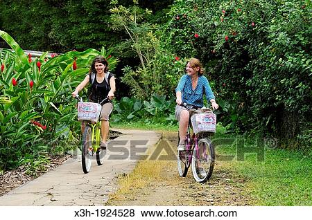 Stock Photo - young women going for bike ride at Colon Island, Bocas del Toro Archipelago, Republic of Panama, Central America. Fotosearch
