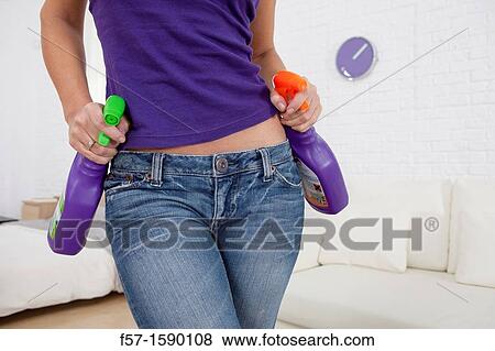 Young women holding detergents on her hips View Large Photo Image Stock Photo - Young women holding detergents on her hips. Fotosearch
