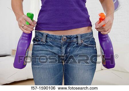 Young women holding detergents on her hips View Large Photo Image Stock Photograph - Young women holding detergents on her hips. Fotosearch