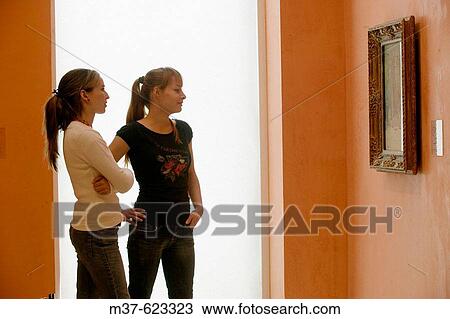 Young women in art gallery View Large Photo Image Stock Image - Young women in art gallery. Fotosearch