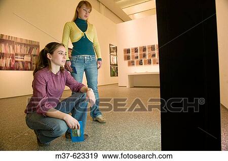 Young women in art gallery View Large Photo Image Stock Photo - Young women in art gallery. Fotosearch