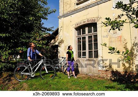 young women in front of the former railway station of Bellou-sur-Huisne, Remalard, Orne department, Lower Normandy region, France, Western Europe. View Large Photo Image Stock Image - young women in front of the former railway station of Bellou-sur-Huisne, Remalard, Orne department, Lower Normandy region, France, Western Europe.. Fotosearch