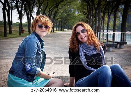 Stock Photograph - Young women in the park on the lake in Chicago IL.. Fotosearch