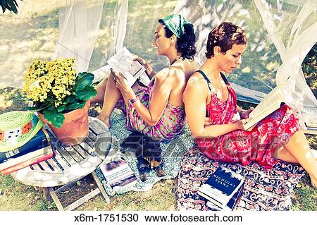 Stock Image - young women reading books. Fotosearch