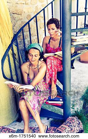 Stock Image - young women reading books. Fotosearch