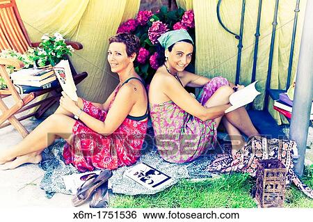 Stock Photograph - young women reading books. Fotosearch