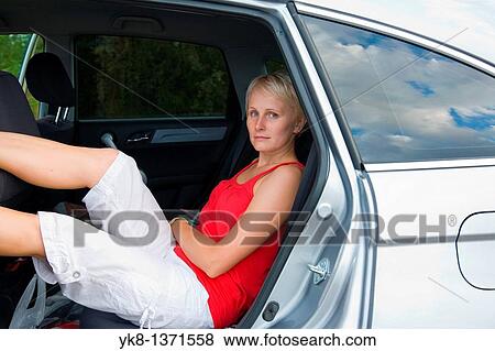 Young women sitting in car on road trip View Large Photo Image Stock Photo - Young women sitting in car on road trip. Fotosearch