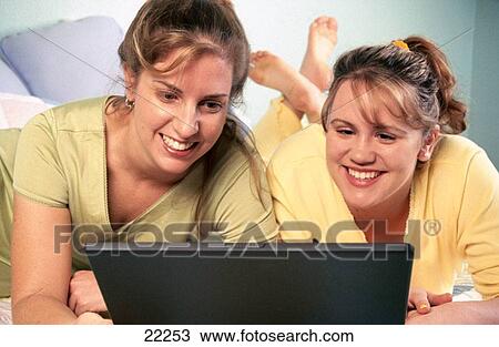 Young women use laptop View Large Photo Image Stock Image - Young women use laptop. Fotosearch