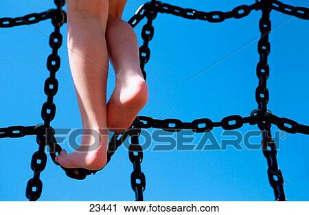 Youth climbing chain ladder View Large Photo Image Stock Image - Youth climbing chain ladder. Fotosearch