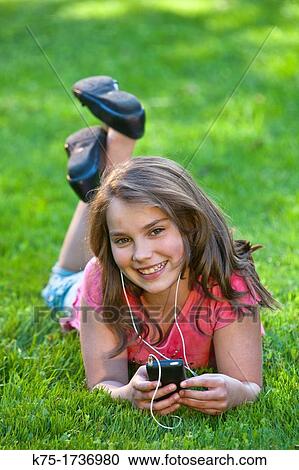 Youth listening to music outdoors View Large Photo Image Stock Image - Youth listening to music outdoors. Fotosearch