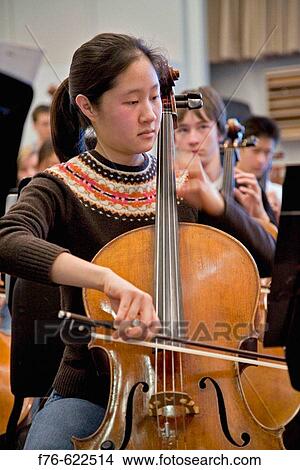 Youth Symphony Orchestra rehearsal, playing the cello View Large Photo Image Picture - Youth Symphony Orchestra rehearsal, playing the cello. Fotosearch
