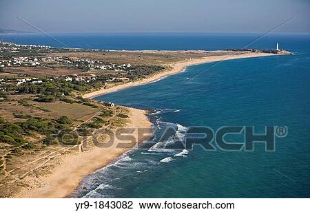 Stock Image - Zahora beach Caos de Meca with Trafalgar's lighthouse, aerial view Cadiz area Spain On the horizon line are the mountains fo Marroco.. Fotosearch