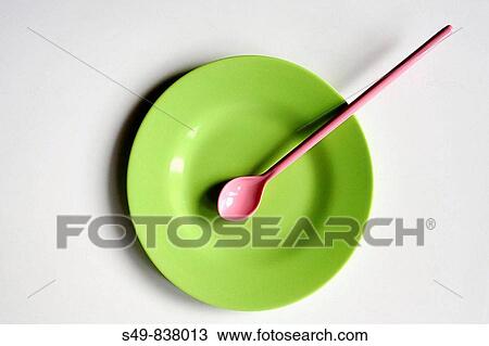 zenithal view of a plastic color plate and spoon on white background View Large Photo Image Stock Image - zenithal view of a plastic color plate and spoon on white background. Fotosearch