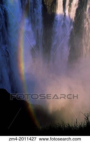 ZIMBABWE, VICTORIA FALLS, ZAMBEZI RIVER, DETAIL WITH RAINBOW. View Large Photo Image Stock Photo - ZIMBABWE, VICTORIA FALLS, ZAMBEZI RIVER, DETAIL WITH RAINBOW.. Fotosearch