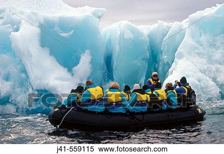 Zodiac with tourists. Past Jade coloured iceberg. Dumont d? Urville, Antarctica. View Large Photo Image Stock Photography - Zodiac with tourists. Past Jade coloured iceberg. Dumont d? Urville, Antarctica.. Fotosearch