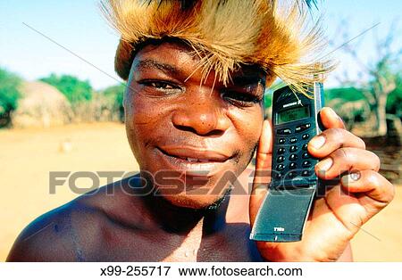 Zulu tribal young man with his mobile phone in Eshowe. Zululand. KwaZulu-Natal. South Africa View Large Photo Image Stock Photo - Zulu tribal young man with his mobile phone in Eshowe. Zululand. KwaZulu-Natal. South Africa. Fotosearch