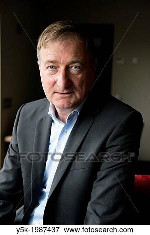 Zundert, Netherlands. Author of pocketbooks, portrayed in his living room. View Large Photo Image Stock Photo - Zundert, Netherlands. Author of pocketbooks, portrayed in his living room.. Fotosearch