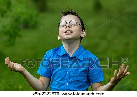 Stock Image - A boy of twelve years in the garden.. Fotosearch
