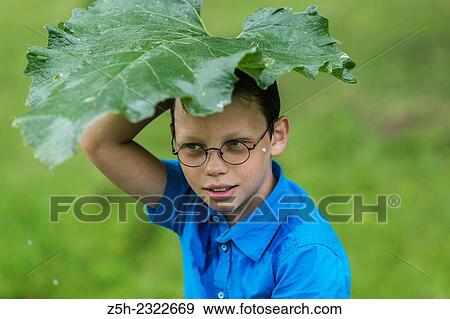 Stock Photo - A boy of twelve years in the garden.. Fotosearch