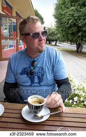 American man living in Poland enjoying his espresso at a sidewalk cafe. Rawa Mazowiecka Central Poland. View Large Photo Image Stock Photo - American man living in Poland enjoying his espresso at a sidewalk cafe. Rawa Mazowiecka Central Poland.. Fotosearch