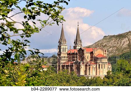 Basilica of Santa Maria la Real, religious Catholic cult temple designed by Roberto Frassinelli and built between 1877 and 1901 by architect Federico Soriano and Aparicio, Neo-Romanesque, built entirely of pink limestone. Covadonga, Asturias, Spain View Large Photo Image Stock Photo - Basilica of Santa Maria la Real, religious Catholic cult temple designed by Roberto Frassinelli and built between 1877 and 1901 by architect Federico Soriano and Aparicio, Neo-Romanesque, built entirely of pink limestone. Covadonga, Asturias, Spain. Fotosearch