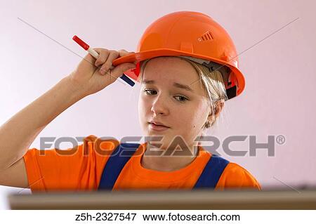 Beautiful girl-builder with a computer. View Large Photo Image Stock Photo - Beautiful girl-builder with a computer.. Fotosearch