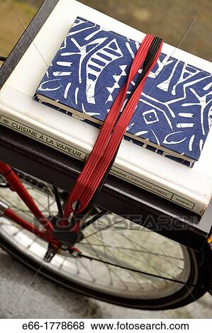 Stock Photo - books on rear bike rack of fold-up bicycle. Fotosearch