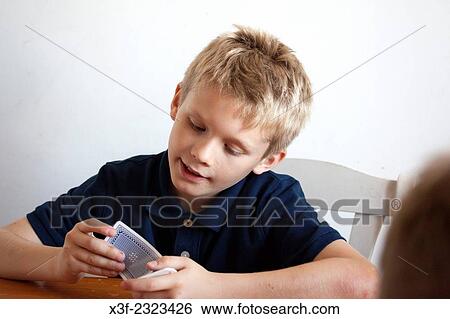 Boy age 10 contemplating his next move in a card game. Lodz Central Poland. View Large Photo Image Stock Photograph - Boy age 10 contemplating his next move in a card game. Lodz Central Poland.. Fotosearch