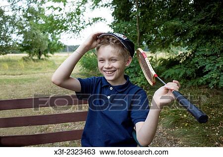 Boy age 10 holding a badminton racket and having a good laugh over his last game. Zawady Central Poland. View Large Photo Image Stock Image - Boy age 10 holding a badminton racket and having a good laugh over his last game. Zawady Central Poland.. Fotosearch