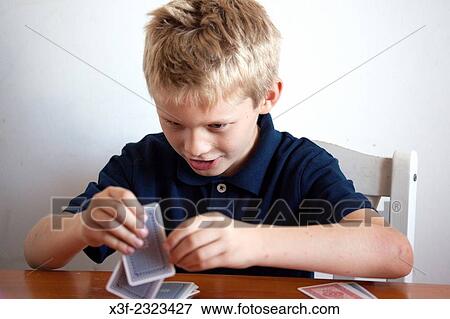 Boy age 10 playing card game. Lodz Central Poland. View Large Photo Image Stock Photo - Boy age 10 playing card game. Lodz Central Poland.. Fotosearch