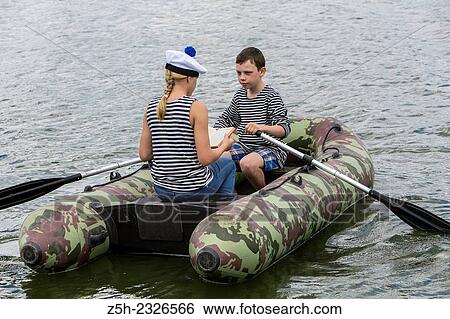 Boy and girl of twelve years in a rubber boat on the river going. View Large Photo Image Stock Photograph - Boy and girl of twelve years in a rubber boat on the river going.. Fotosearch