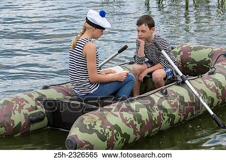 Boy and girl of twelve years in a rubber boat on the river going. View Large Photo Image Stock Photography - Boy and girl of twelve years in a rubber boat on the river going.. Fotosearch