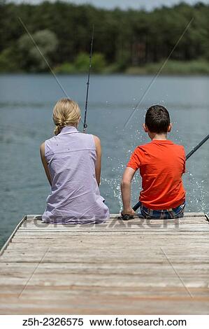 Boy and girl of twelve years on the pond fish udyat. View Large Photo Image Stock Photography - Boy and girl of twelve years on the pond fish udyat.. Fotosearch