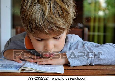 Boy reading book View Large Photo Image Picture - Boy reading book. Fotosearch