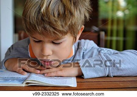 Stock Photography - Boy reading book. Fotosearch