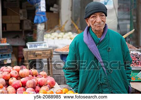 Down Town, Amman, Jordan, Middle-East. Seventy (70) year old owner of a market stall, down town Amman, where he sells regionally produced fruits and vegetables. In a previous life, he worked in the Rotterdam harbor, returning home after his retirement. View Large Photo Image Stock Photography - Down Town, Amman, Jordan, Middle-East. Seventy (70) year old owner of a market stall, down town Amman, where he sells regionally produced fruits and vegetables. In a previous life, he worked in the Rotterdam harbor, returning home after his retirement.. Fotosearch