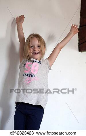 Excited young Polish girl screaming with arms in the air. Lodz Central Poland. View Large Photo Image Stock Image - Excited young Polish girl screaming with arms in the air. Lodz Central Poland.. Fotosearch