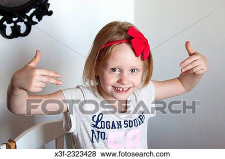 Expressive happy young girl age six giving hand signals with both arms in air. Lodz Central Poland. View Large Photo Image Stock Photo - Expressive happy young girl age six giving hand signals with both arms in air. Lodz Central Poland.. Fotosearch