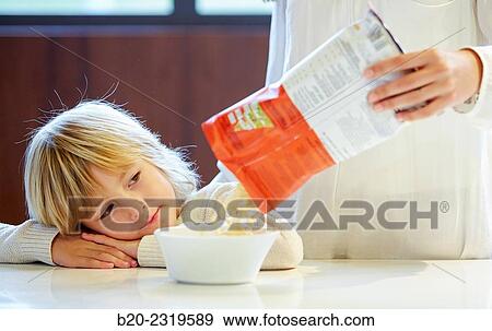 Family in the kitchen. Child. Packaged foods. View Large Photo Image Stock Photo - Family in the kitchen. Child. Packaged foods.. Fotosearch