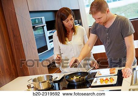Family in the kitchen. Couple. Healthy eating. Healthy growth. Cooking fish and vegetable skewer. View Large Photo Image Stock Image - Family in the kitchen. Couple. Healthy eating. Healthy growth. Cooking fish and vegetable skewer.. Fotosearch