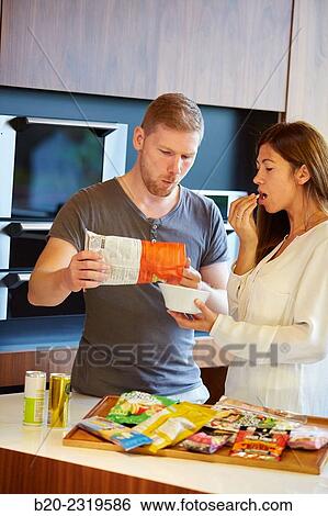Family in the kitchen. Couple. Packaged foods. View Large Photo Image Stock Photograph - Family in the kitchen. Couple. Packaged foods.. Fotosearch